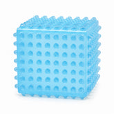 SensoFlex sensory squeeze cube toy in bright green; pink SensoFlex anti-stress squeeze cube on display stand; blue textured squeeze cube sensory toy; SensoFlex squeeze cube held in hand; textured sensory cube toy with raised bumps; pink blue and bright green SensoFlex squeeze cubes; anti-stress squeeze cube display of 12; SensoFlex tactile fidget toy