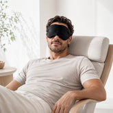 Sleep Mask with included earplugs; soft lightweight Sleep Mask viewed from the front; Sleep Mask laid flat beside earplugs; lightweight sleep mask packed for travel; Sleep Mask and earplugs with travel essentials; soft sleep mask for home or travel
