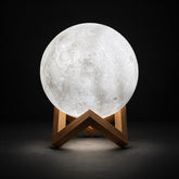 Use only the option that matches the image shown: Deluxe Moon Lamp on its wooden stand; Illuminated Deluxe Moon Lamp globe; Deluxe Moon Lamp glowing red; Deluxe Moon Lamp glowing blue; Remote control for the Deluxe Moon Lamp; USB charging cable for the Deluxe Moon Lamp; Detachable wooden moon lamp stand
