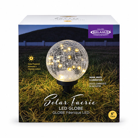 Use only descriptions that match the image shown: Solar Faerie LED Globe with detachable garden stake; Hand-blown crackle glass solar globe; Solar Faerie LED Globe illuminated at dusk; Crackle glass globe displayed in a garden; Solar LED globe on a patio table without its stake; Close-up of the Solar Faerie LED Globe crackle glass; Medium Solar Faerie LED Globe, 15 cm diameter.