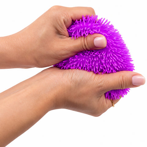 Squiggles Fidget Sensory Toy in assorted colours; squishy TPR sensory toy held in hand; orange Squiggles Fidget sensory toy; purple squishy fidget toy; colourful sensory squeeze toy with maltose filling; Squiggles Fidget being squeezed by hand; assorted Squiggles sensory toys in bright colours; 7.5 cm squishy sensory fidget toy