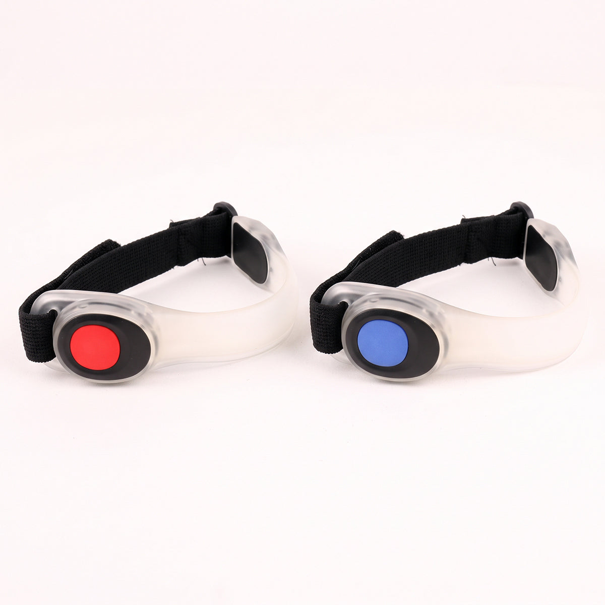 Use only descriptions that match the image shown: LED Safety Arm Bands 2-pack; LED arm band with steady illumination; LED arm band in flashing mode; Adjustable hook-and-loop strap on an LED arm band; Reflective pull tab on the LED safety arm band; LED Safety Arm Band worn while running; LED arm band worn while cycling; CR2032 battery compartment on the LED arm band