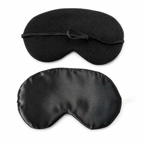 Sleep Mask with included earplugs; soft lightweight Sleep Mask viewed from the front; Sleep Mask laid flat beside earplugs; lightweight sleep mask packed for travel; Sleep Mask and earplugs with travel essentials; soft sleep mask for home or travel