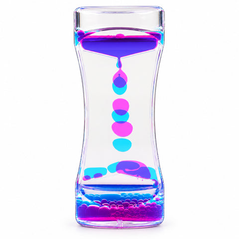 Use only descriptions that match the image shown: Lava Flow Sensory Desktop Toy with colourful bubbles; Clear acrylic liquid-motion sensory toy; Complementary coloured droplets flowing through the Lava Flow toy; Lava Flow Sensory Desktop Toy on an office desk; Liquid-motion toy in a study space; Lava Flow Sensory Desktop Toy retail displayer of 12; Individually boxed Lava Flow Sensory Desktop Toy.