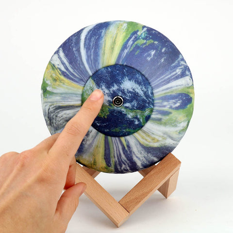 Earth Globe Light with hand pressing on button